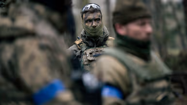 Luitenant Bas op de achtergrond en op de voorgrond onscherpe Oekraïense militairen. 