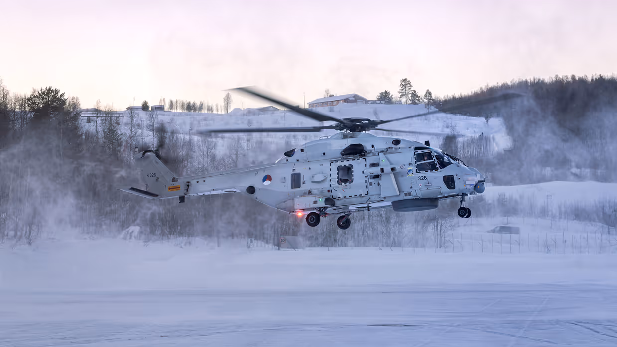 NH90 van het maritieme helikoptersquadron op een besneeuwd vliegveld in Noorwegen tijdens oefening Cold Response, met bemanningsleden zichtbaar in de cockpit.