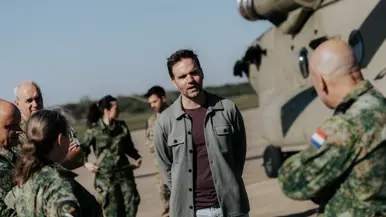 Boswijk in gesprek met militairen op een helikopterplatform.