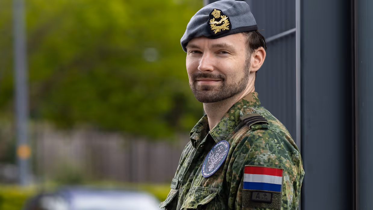 Michael van den Wildenberg draagt een groen vlekkenpak en kijkt in de camera.  
