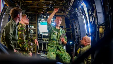Fotocollage van John Butijn aan het werk als instructeur. Eenmaal heeft hij z’n armen over elkaar en kijkt hij in de camera. Een ander moment helpt hij een leerling bij een aambeeld en zit hij met leerlingen in een gedemonteerde helikopter.