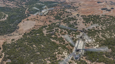 Twee Chinooks van bovenaf vliegend boven Texaans landschap.
