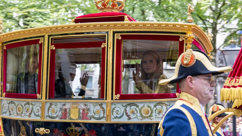 Prinses Amalia en Koning Willem-Alexander zwaaien vanuit de koets op Prinsjesdag 