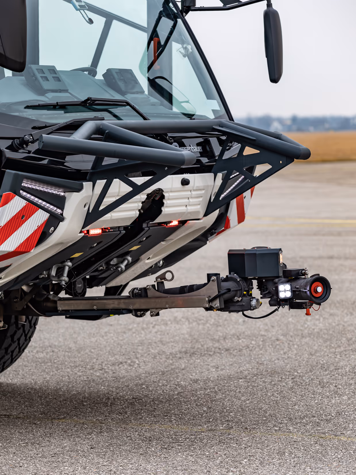 Voorkant brandweervoertuig met beweegbare bumpermonitor. 