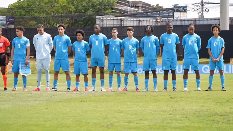 Spelers staan op het veld in een rij opgesteld voorafgaand aan een wedstrijd. 