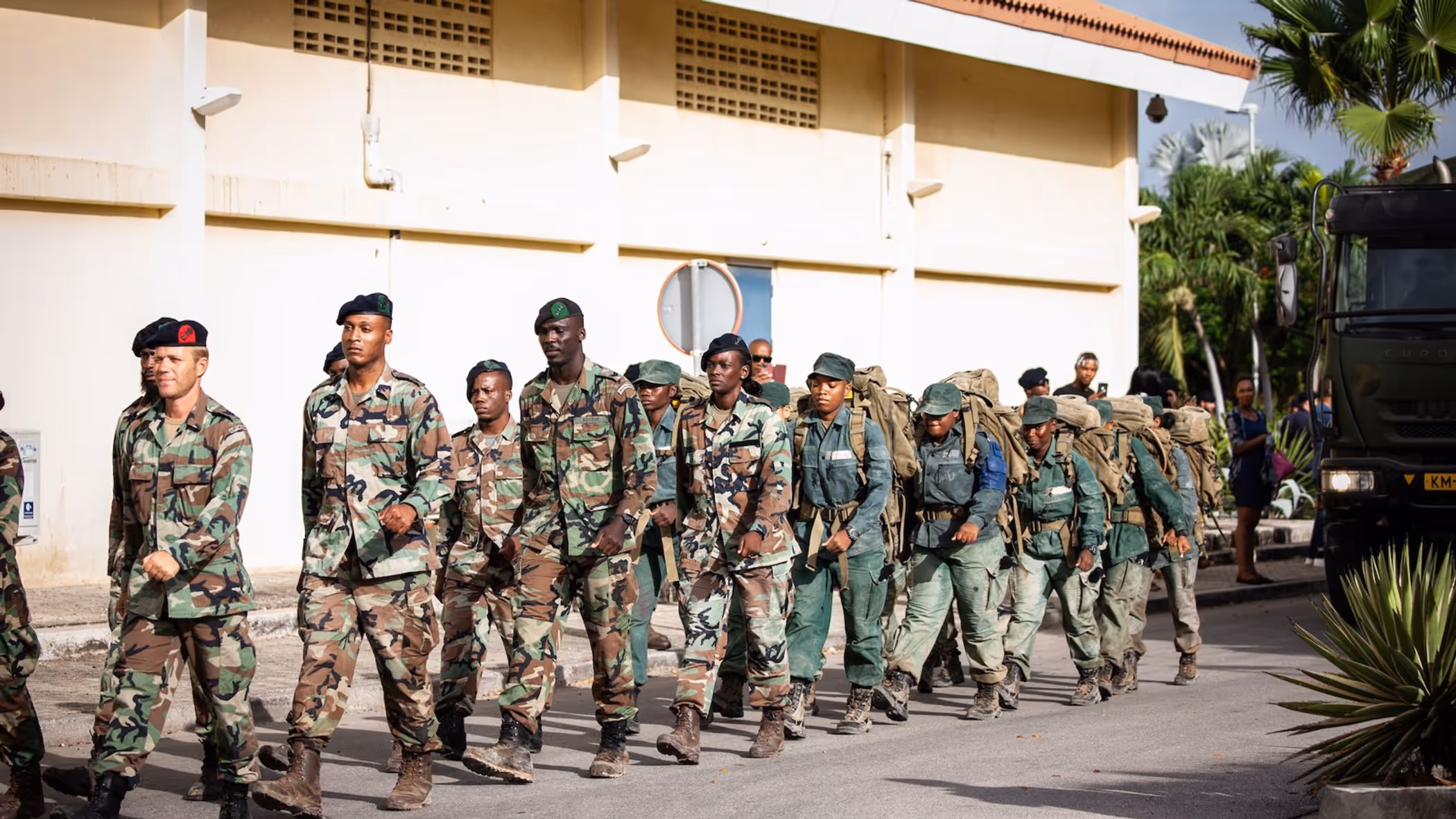 Curaçaose militairen marcheren achter elkaar aan.