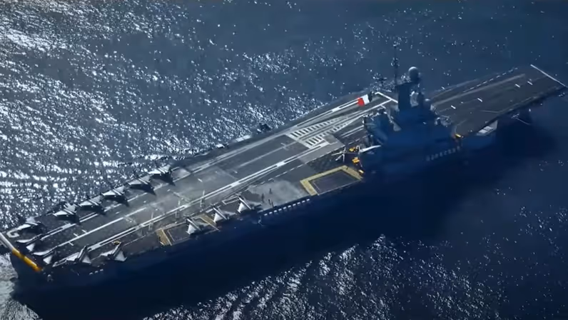 Het vliegdekschip FS Charles de Gaulle geëscorteerd door meerdere varende eenheden. 