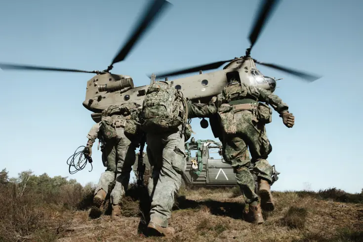 Militairen lopen naar een helikopter
