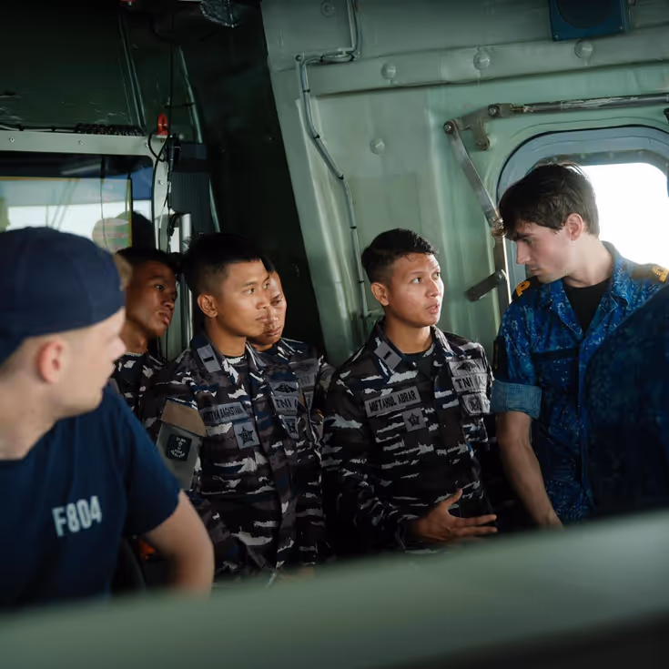 4 Indonesische militairen krijgen een rondleiding op het schip. Zij bevinden zich hier op de brug.