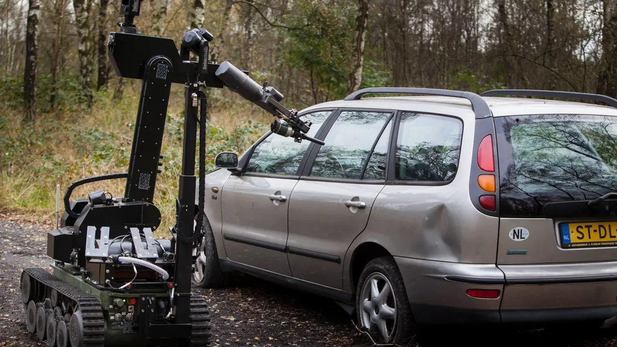 Explosievenrobot tEODor verkent een auto op het oefenterrein in Riel (2014).