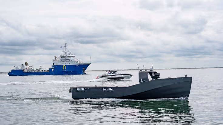Een bemand en onbemand schip op open water.