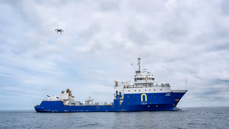 Schip met daarboven een drone.