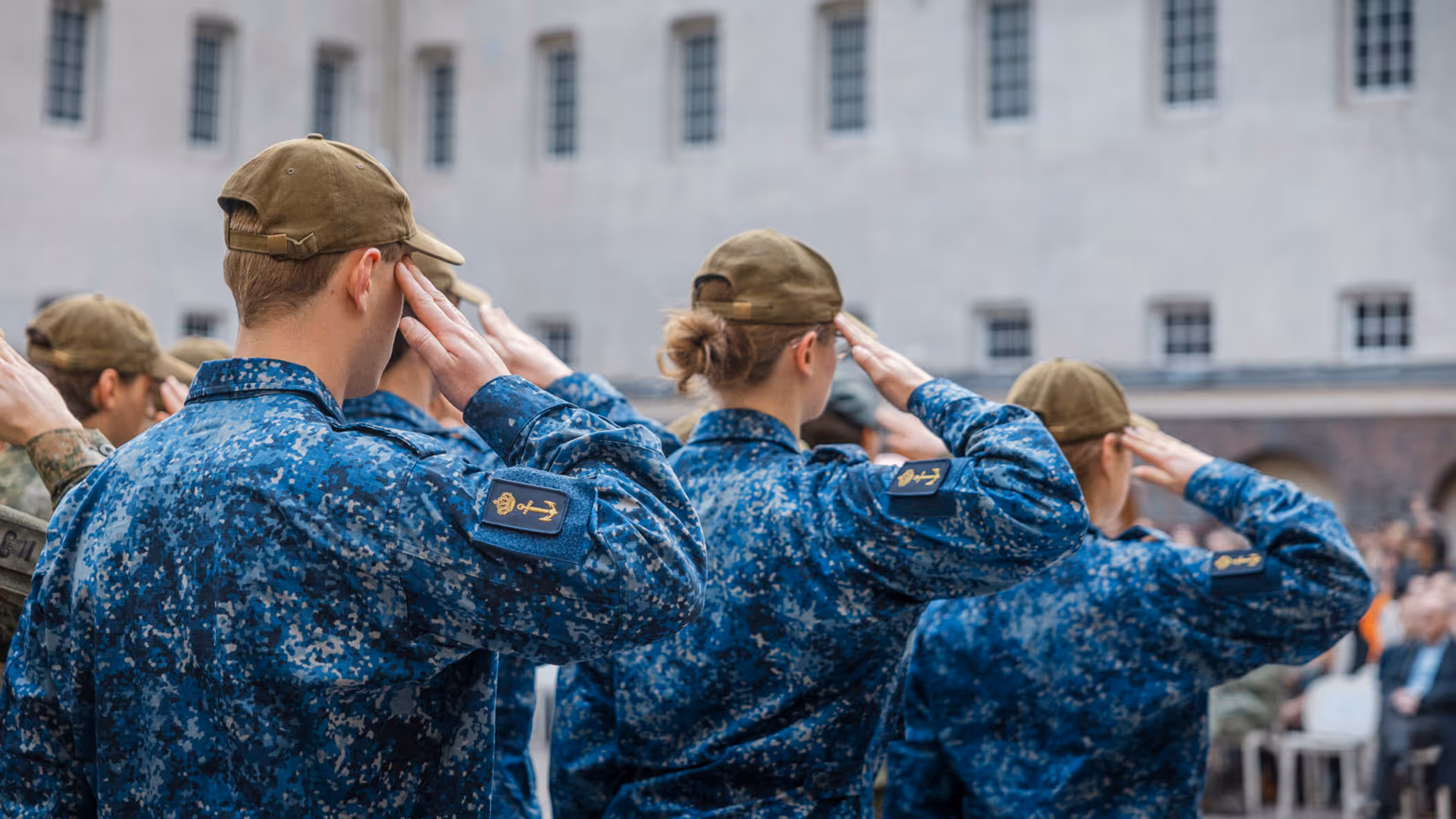 Militairen salueren, op de rug gezien