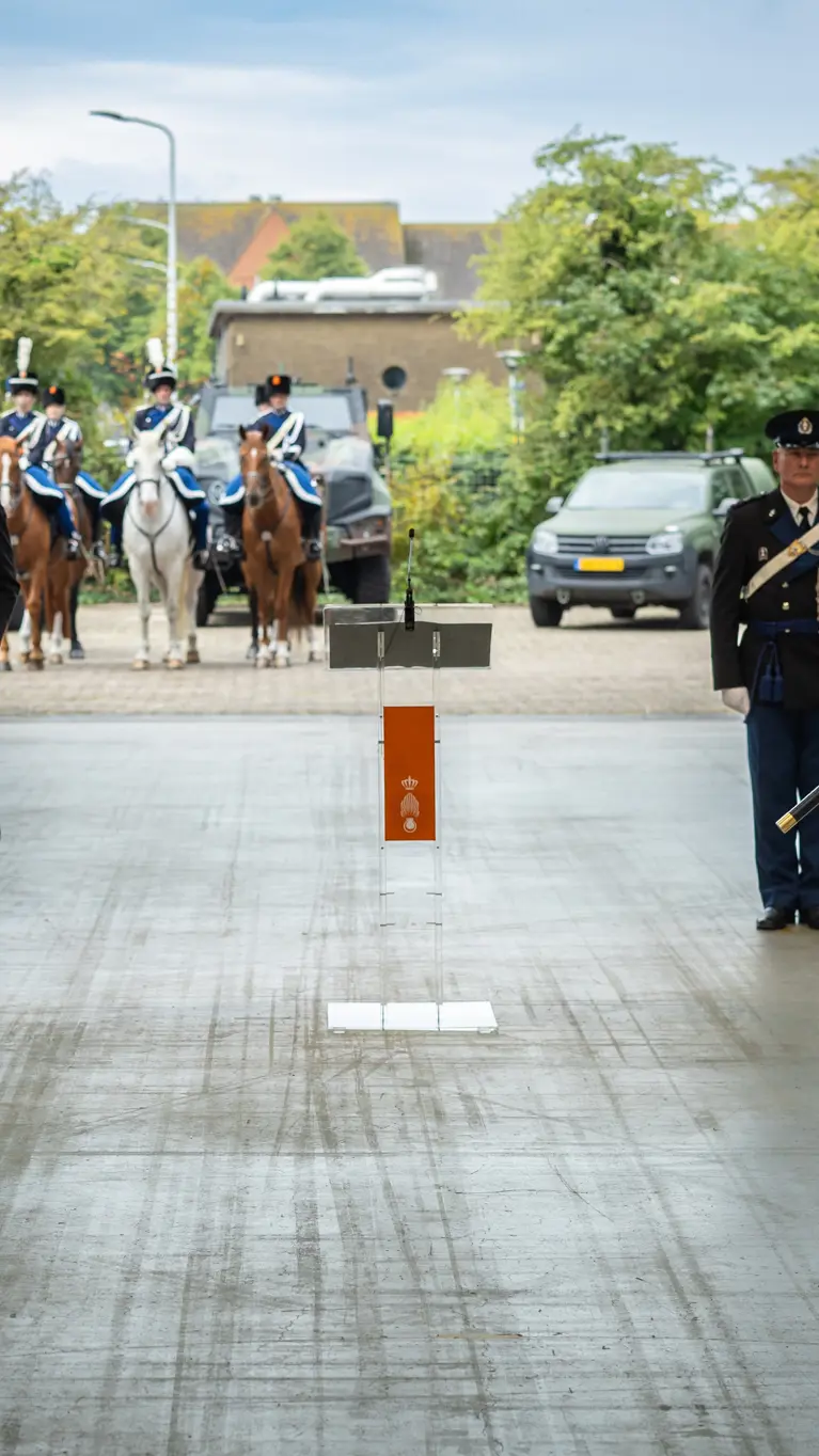 De oude en de nieuwe C-KMar staan opgesteld met het vaandel in de hand.