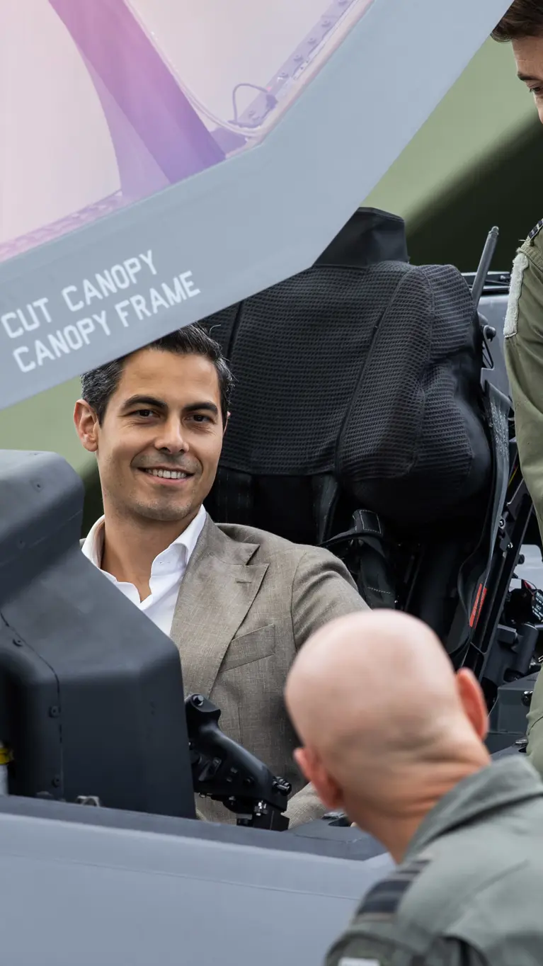 De premier zit in de cockpit van een gevechtsvliegtuig. 