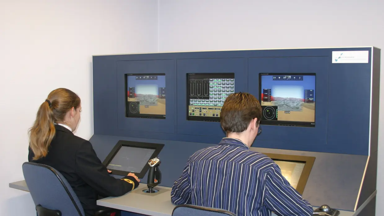 2 mensen zitten achter een computersysteem.