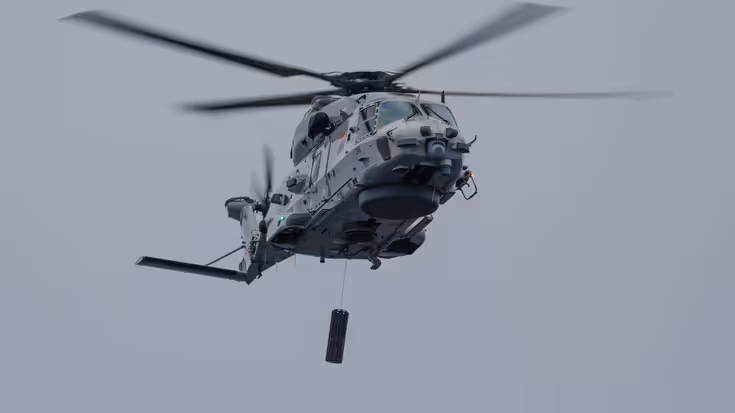 Een NH90-helikopter met daaronder de Long-Range Active Sonar.