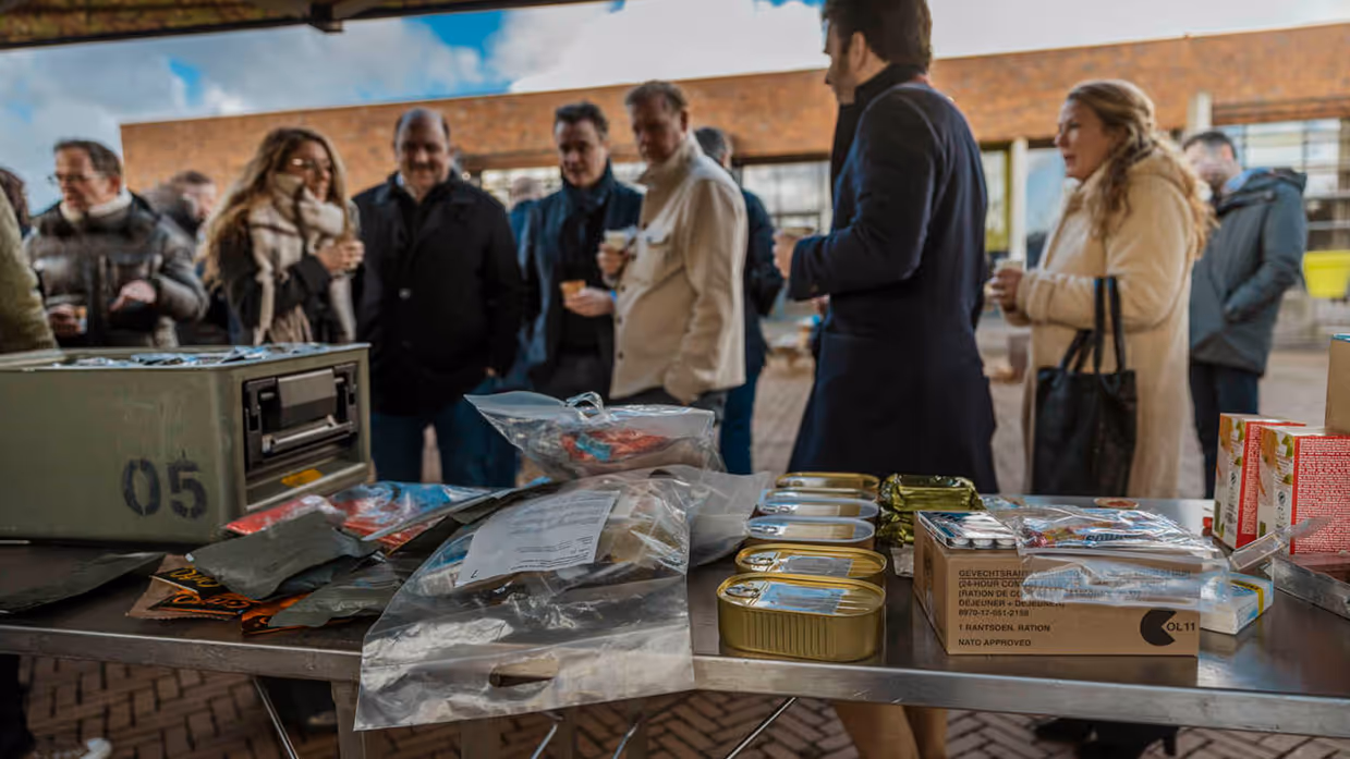 Mensen lopen langs tafel met noodrantsoenen.