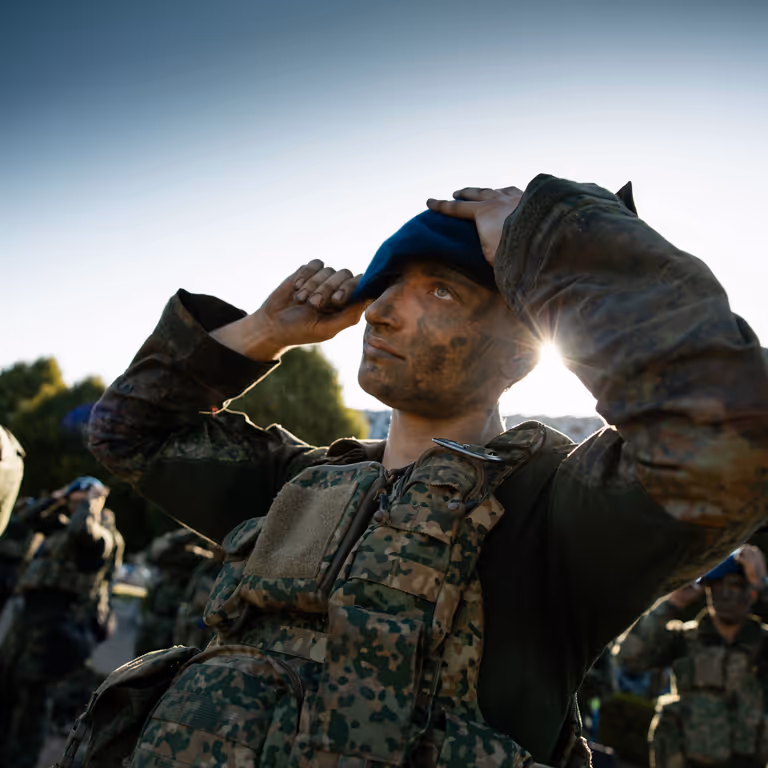 Afbeelding Marechaussee die baret op doet.