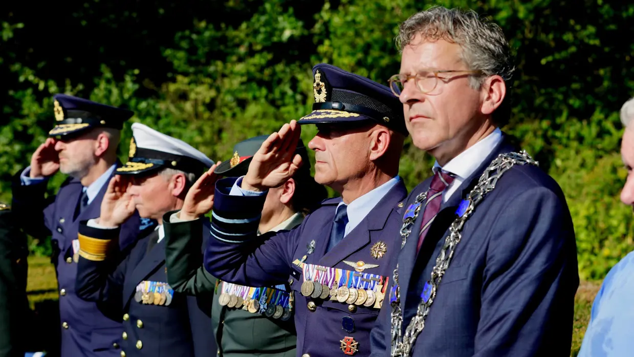 Vier militairen op rij, onder wie luitenant-generaal Steur, brengen de militaire eregroet. Daarnaast staat de Eindhovense burgemeester Jeroen Dijsselbloem.
