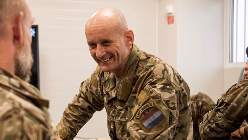  Lachende militair in gesprek met collega.
