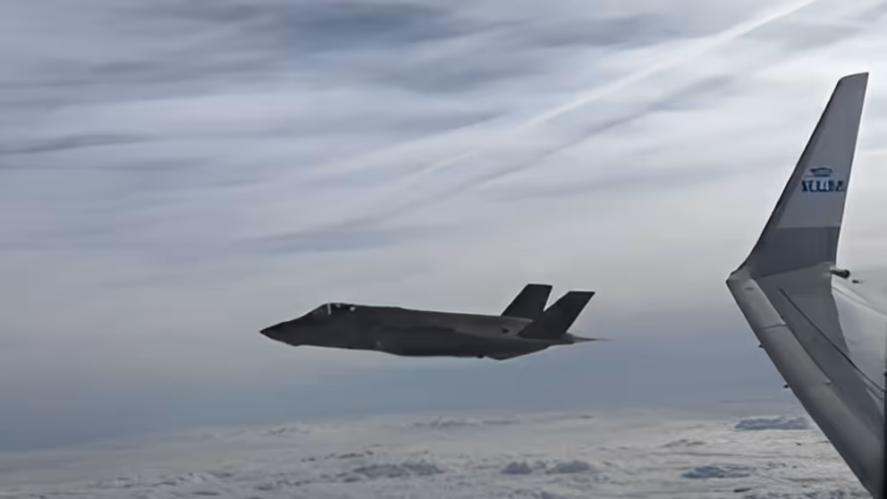 Een van de F35's die olympiers ecorteert vanuit vliegtuig gezien