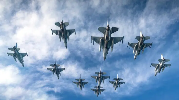 Grote groep F-16's in de lucht.