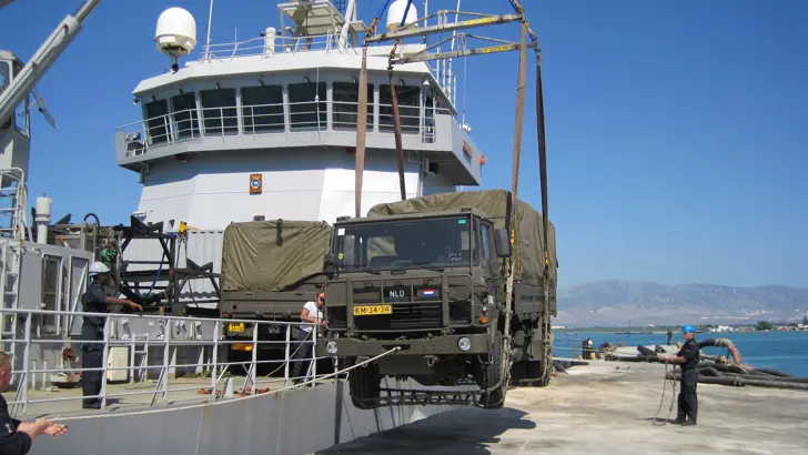 Ondersteuningsvaartuig Zr.Ms. Pelikaan laadt een voertuig uit.